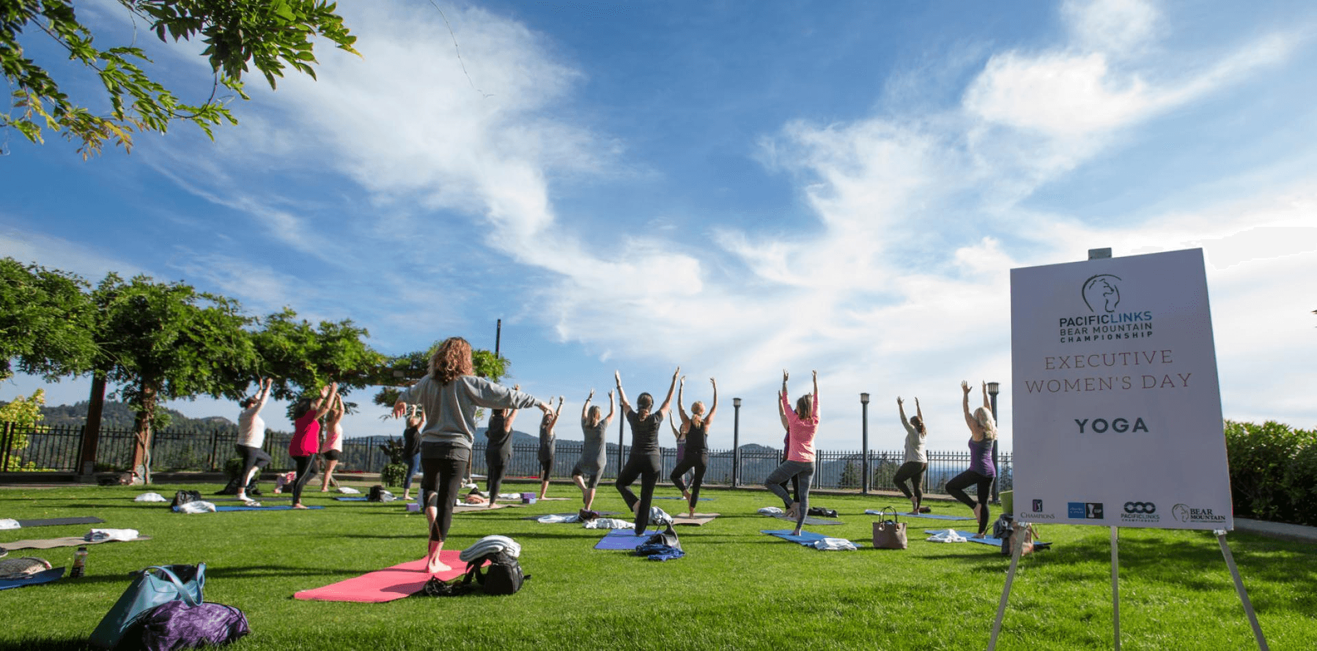 women in a park doing yoga for women's day