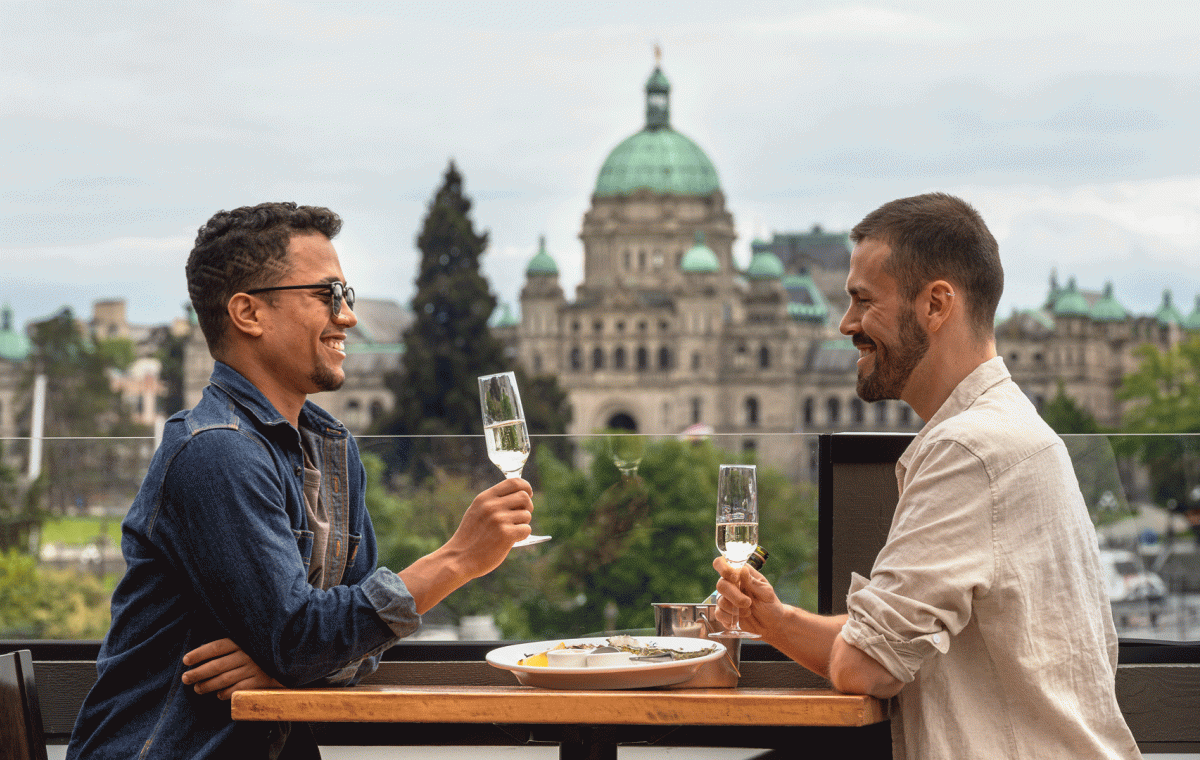 two people drinking sparkling wine and having food