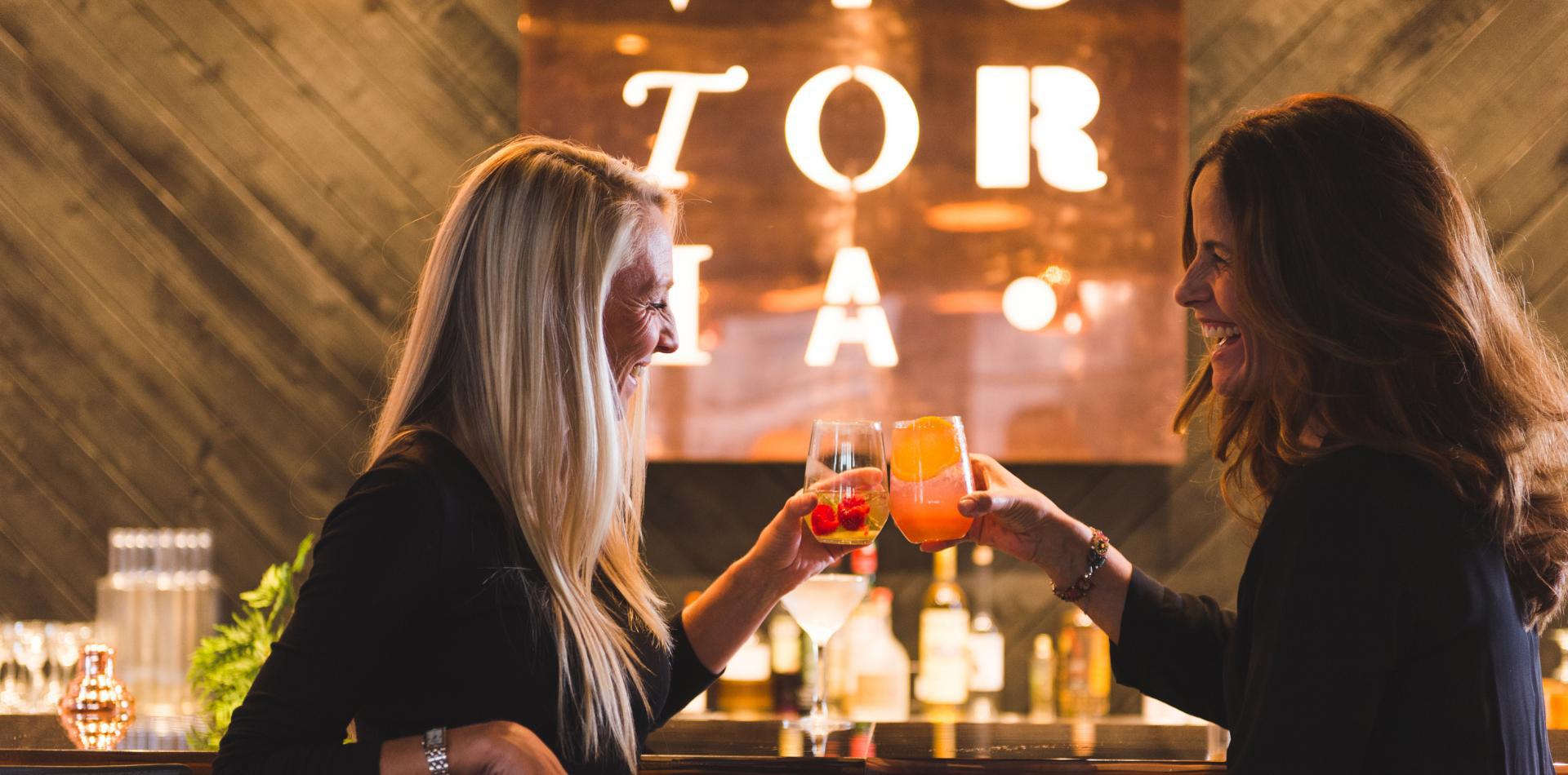 two women cheering cocktails